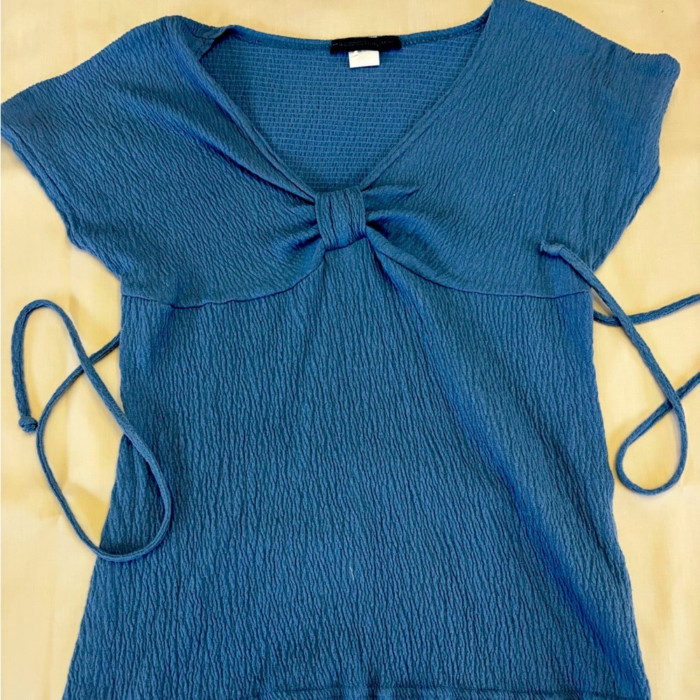Light blue short sleeve top by American city wear. Never worn, smoke free home